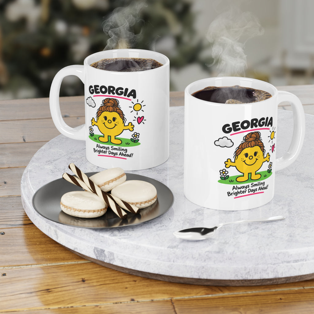 Two white mugs with "GEORGIA" and a smiling sun character.